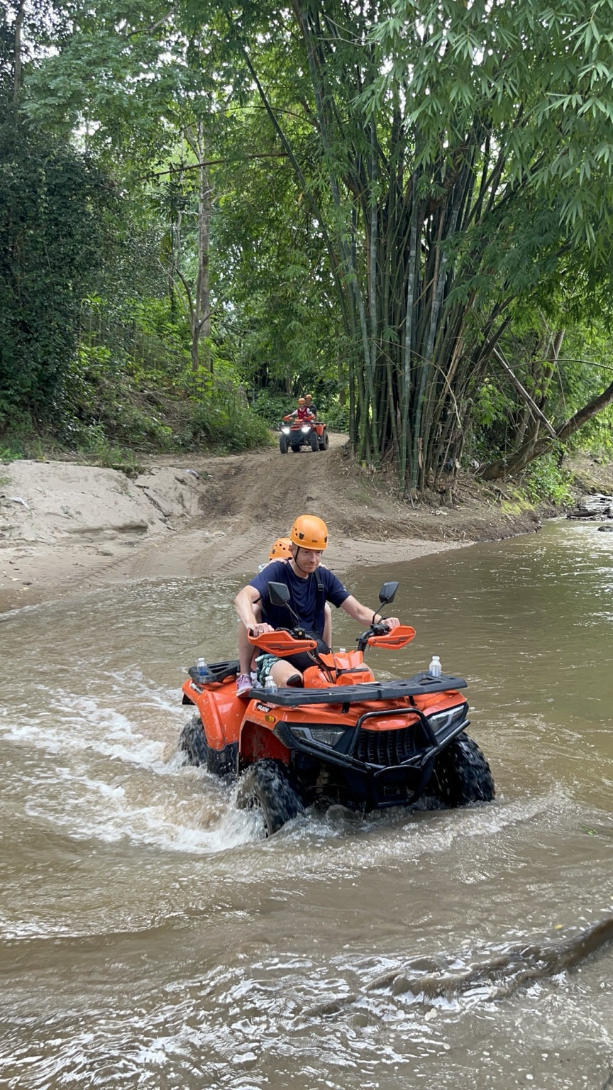 ATV riding through water in Mae Wang